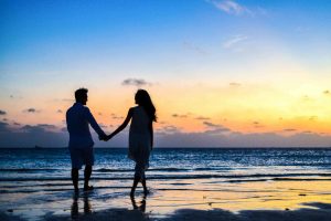 Happy couple walking by the Vancouver sea, representing healthy relationships