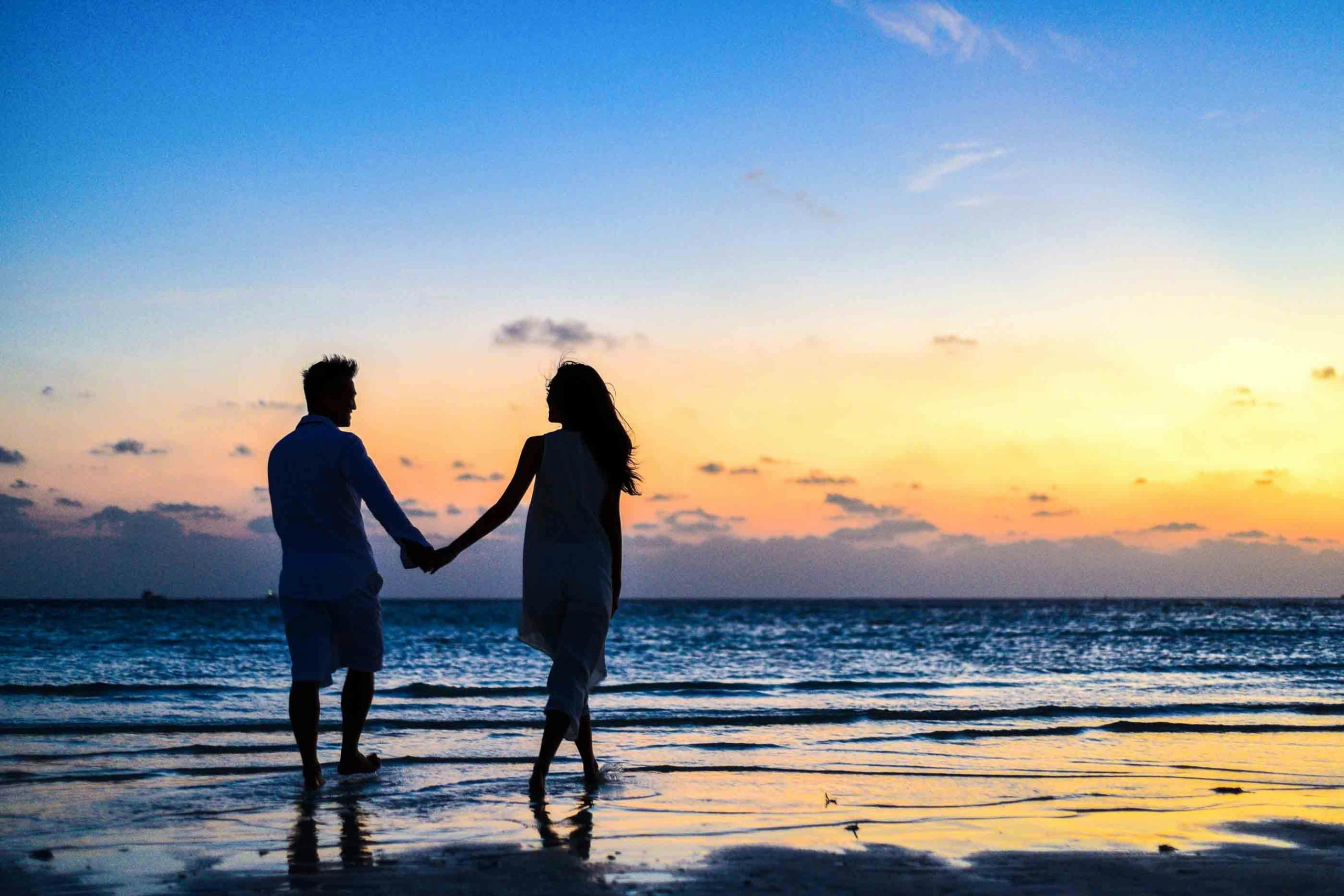 Happy couple walking by the Vancouver sea, representing healthy relationships